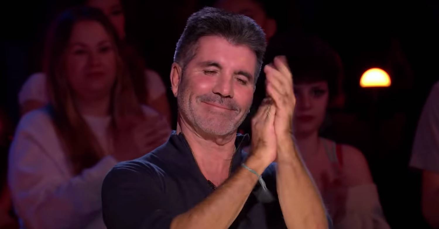 Simon Cowell applauds the Frontline Singers on BGT
