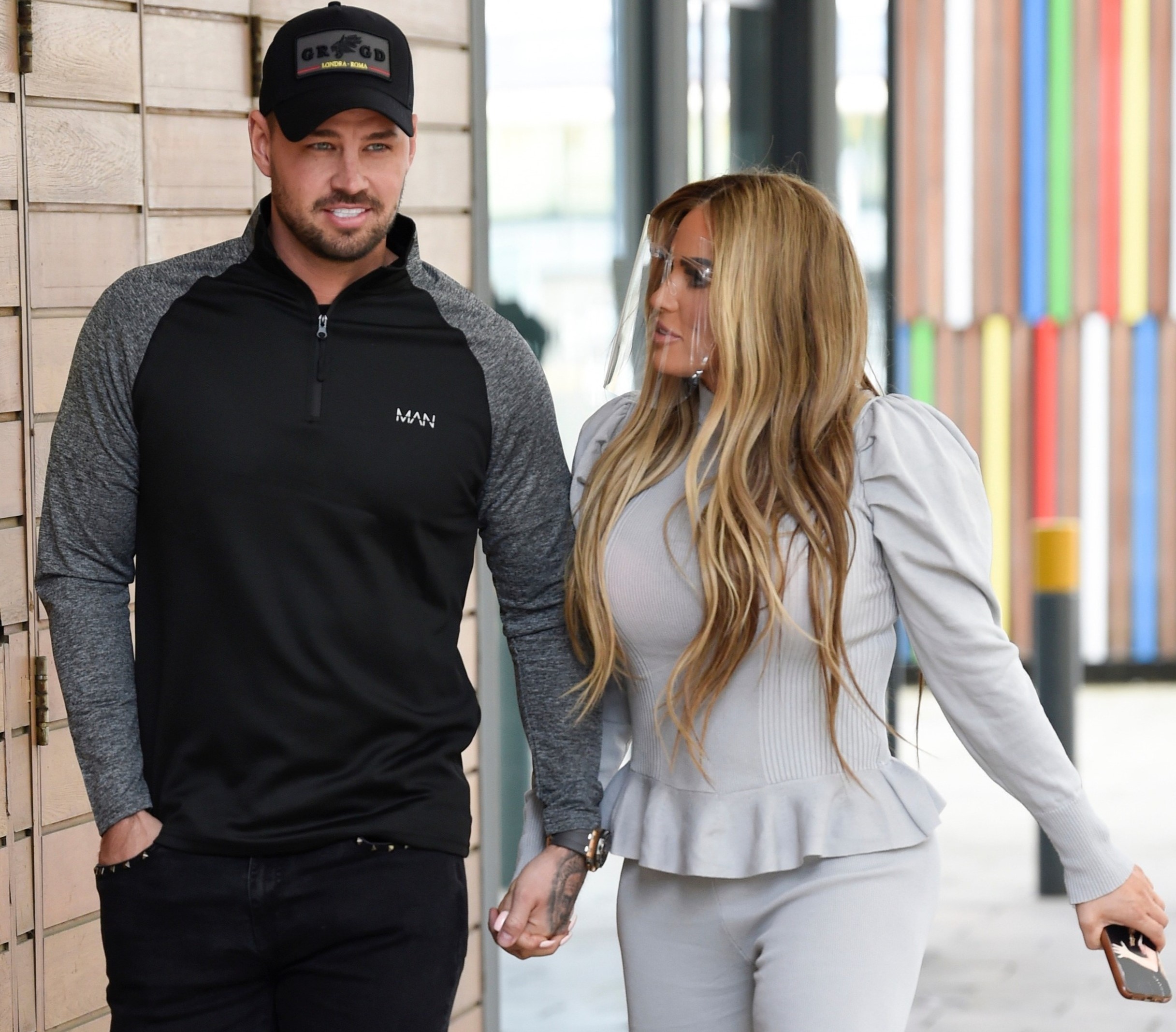 Carl Woods and Katie Price walking hand in hand