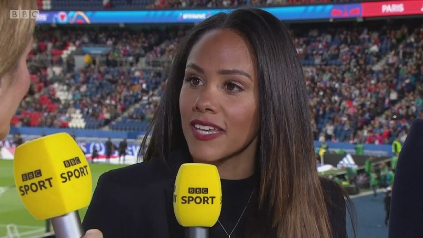 Alex Scott holding a yellow BBC Sport microphone