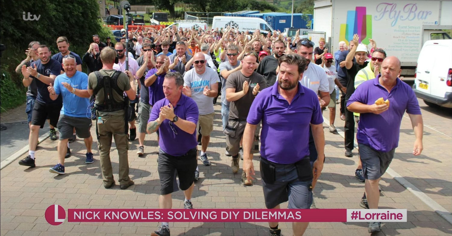 DIY SOS team waling down the street on Lorraine