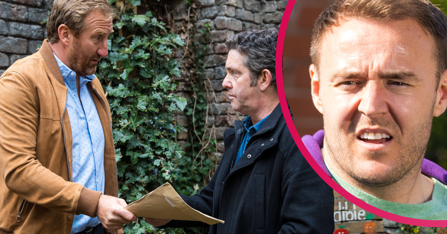 Tyrone and Phill handing over a brown envelope to a man