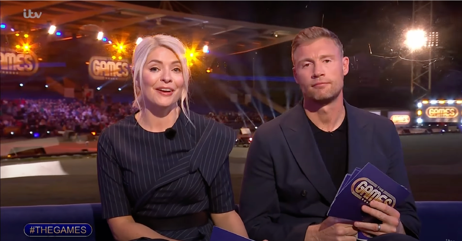 Holly Willoughby in a black dress and Freddie Flintoff in a suit and t-shirt addressing the camera during The Games 