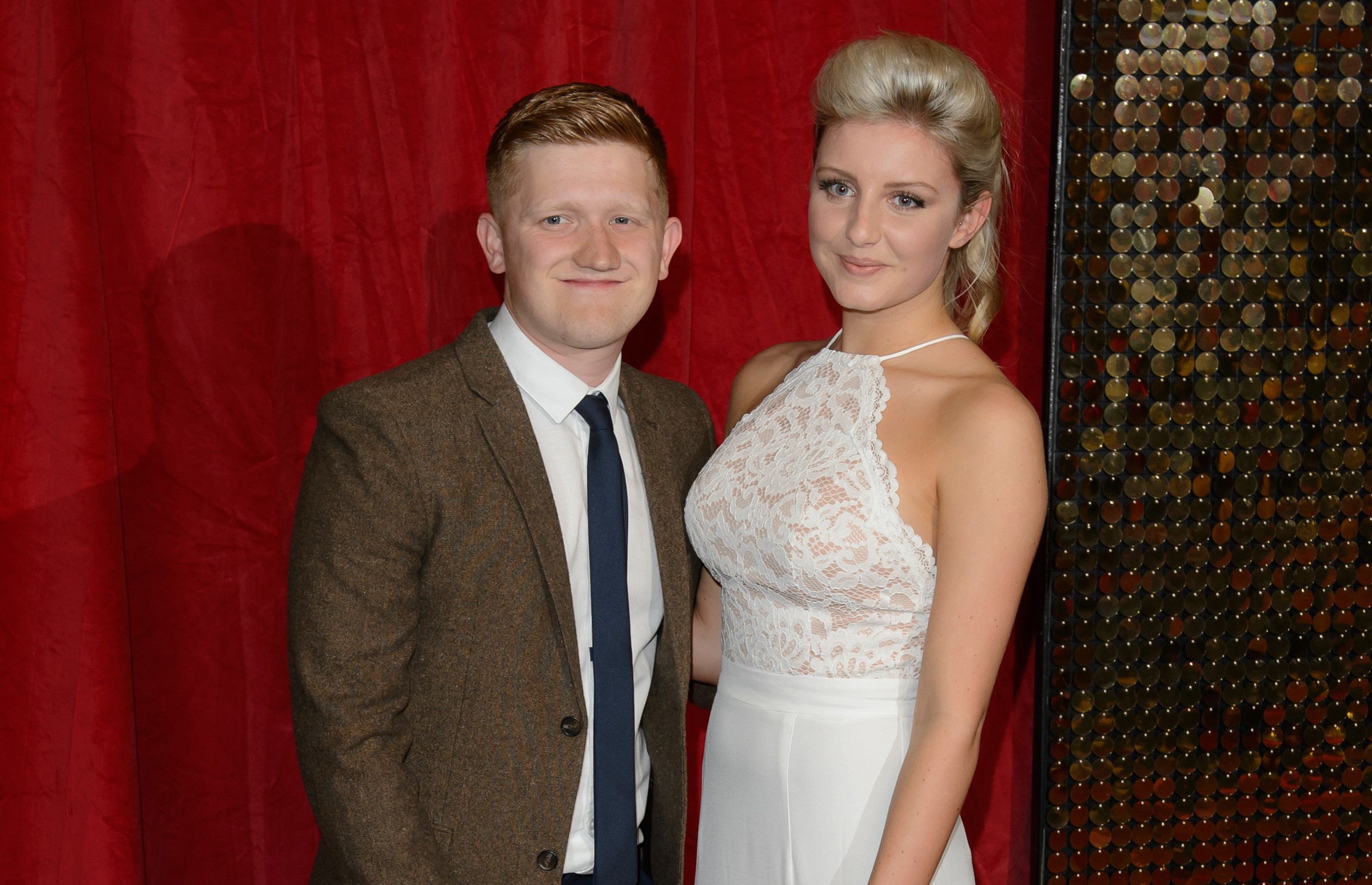 Sam Aston and wife Briony pose on red carpet