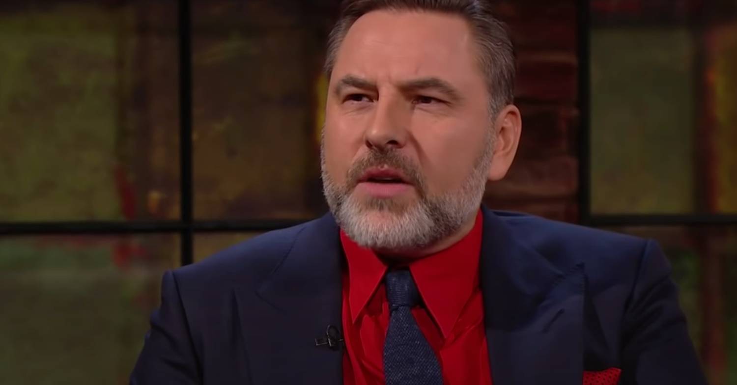 BGT star David Walliams looking confused in a red shirt