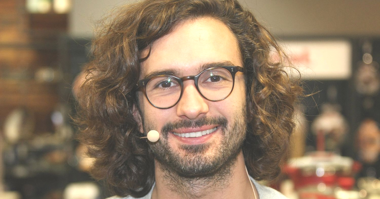  Joe Wicks smiling wearing a head microphone and glasses