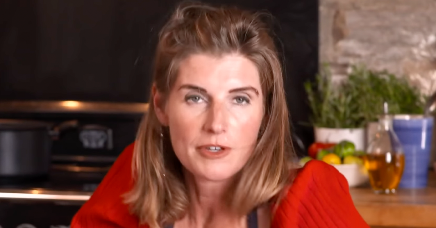 Amanda Owen wearing red sitting in her kitchen