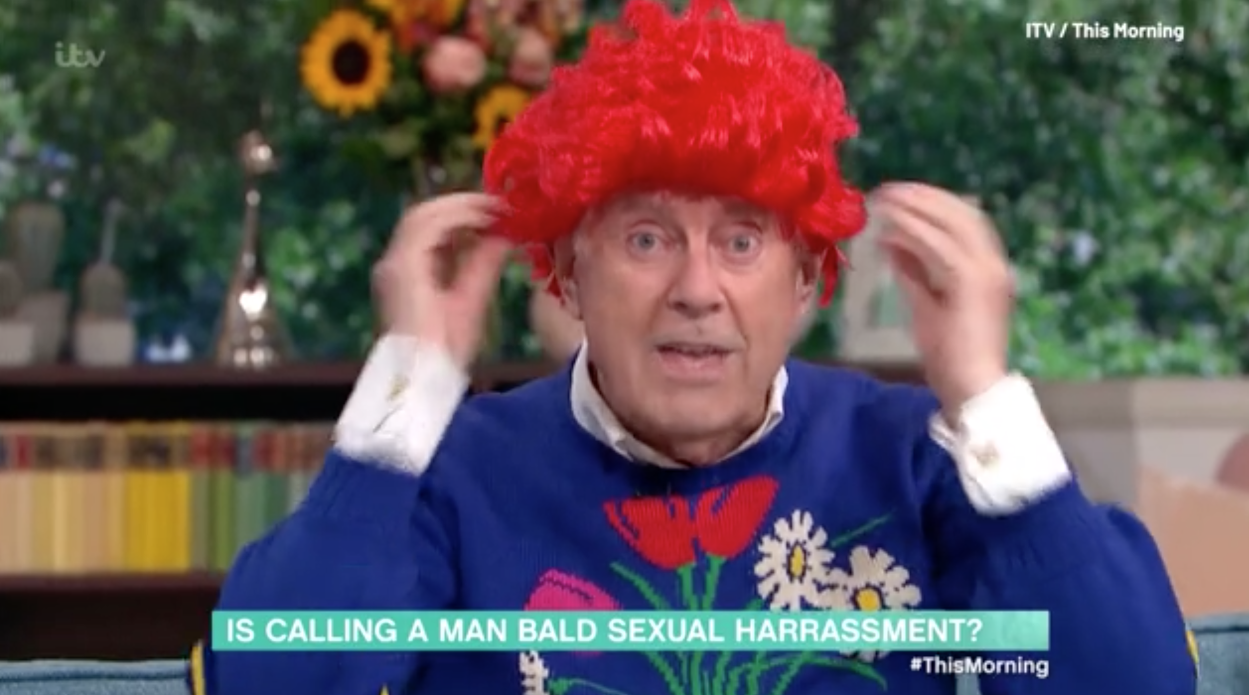 Gyles Brandreth in a red wig looking crazy
