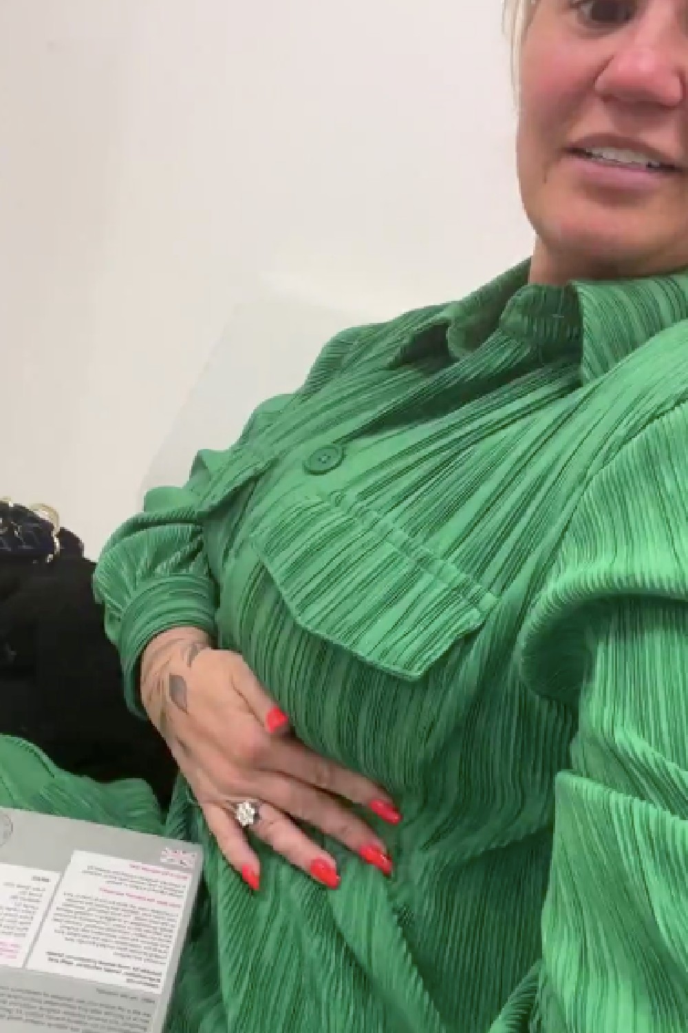 Kerry Katona giving a glimpse of her boobs whilst wearing a green shirt