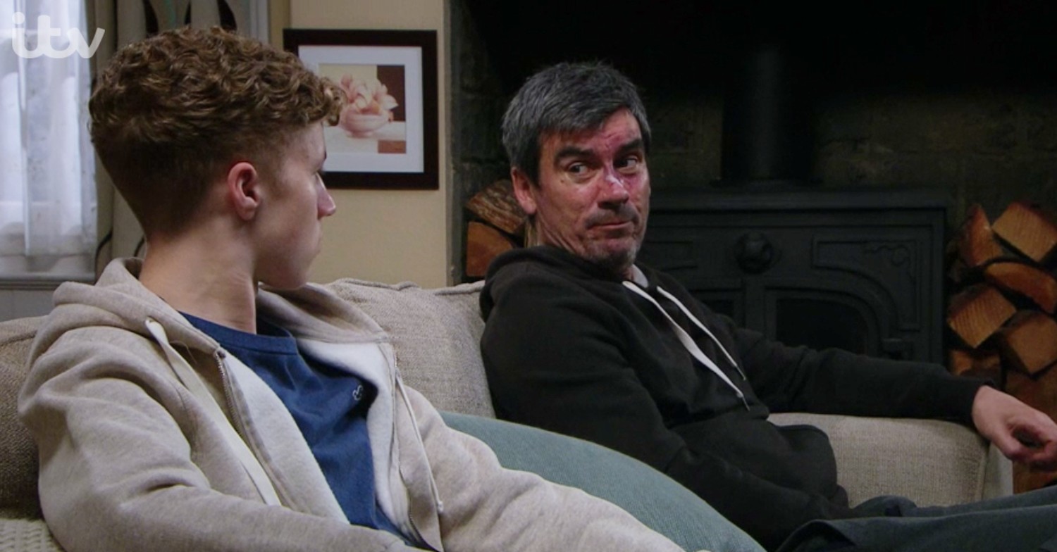 Cain Dingle looking tense during a discussion with Noah on Emmerdale