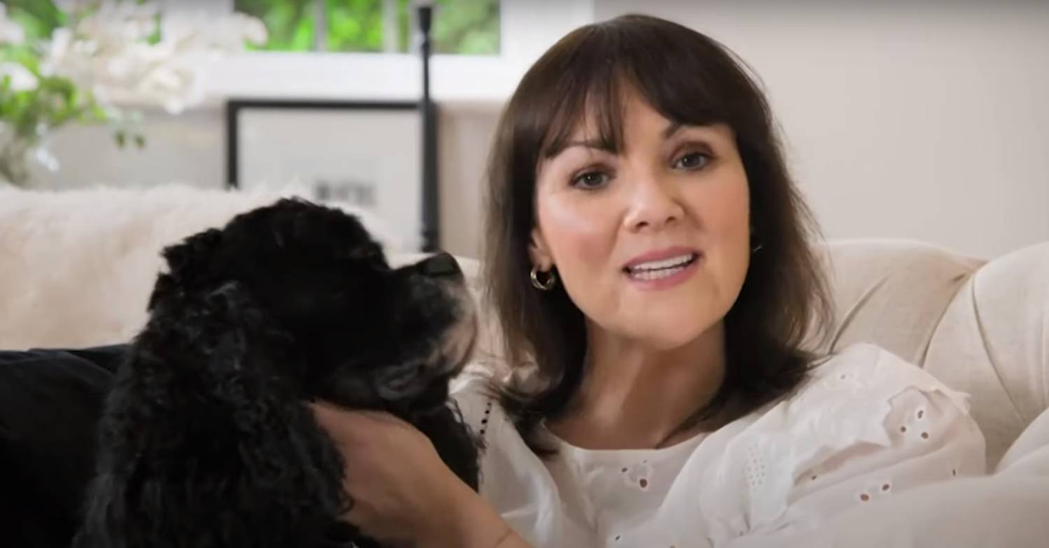 Martine McCutcheon sitting on a cream sofa with her dog