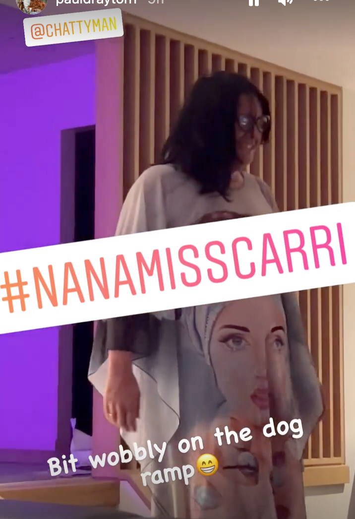 Alan Carr dressed in a kaftan whilst watching Eurovision with former husband Paul Drayton