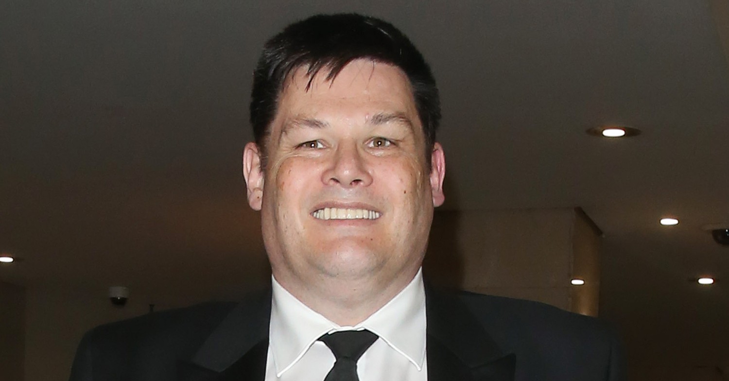 The Chase star Mark Labbett smiling in a black suit