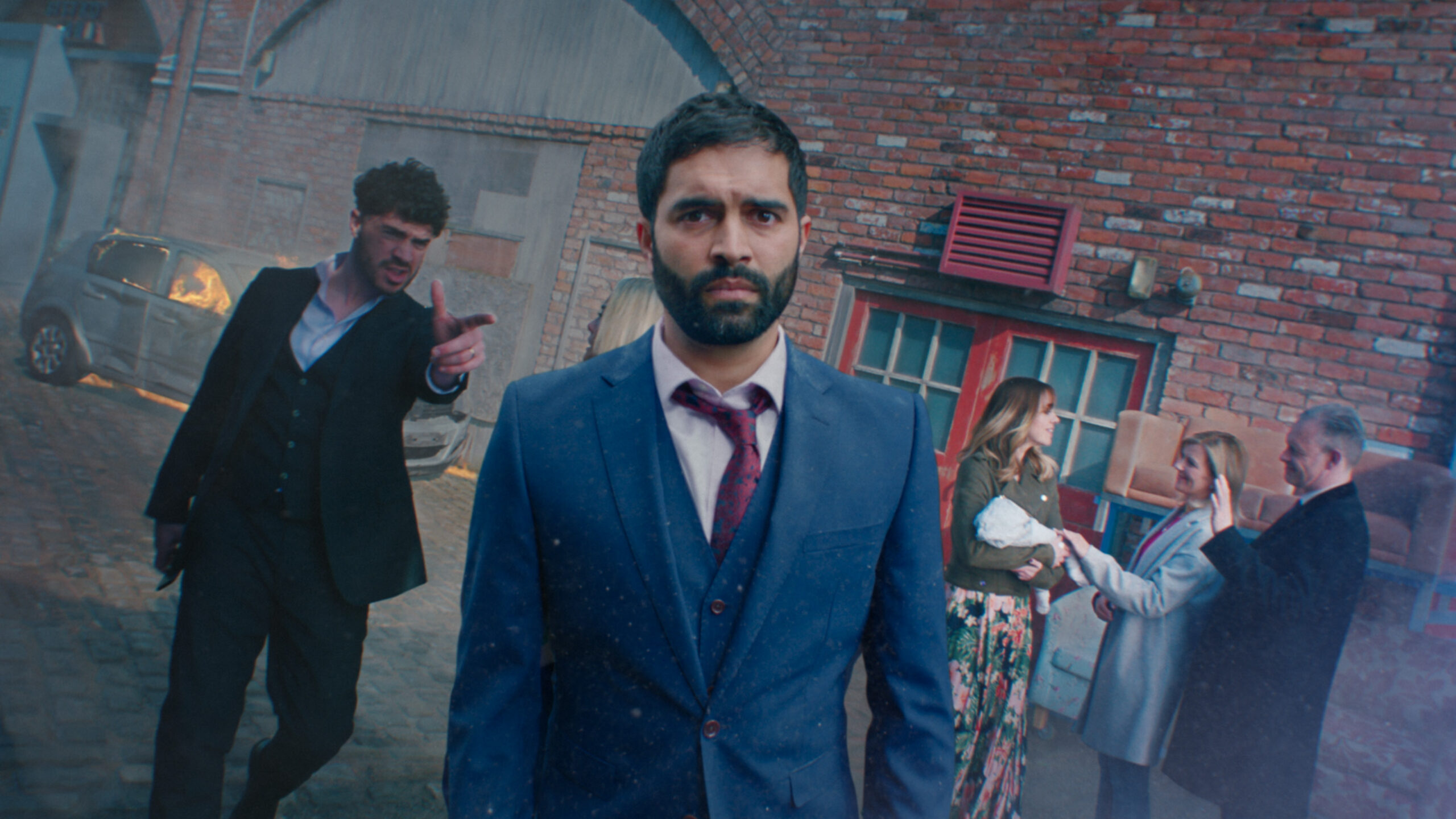 Imran facing the camera as Adam points to him with Toyah, Nick, Leanne and Alfie in the background Coronation Street
