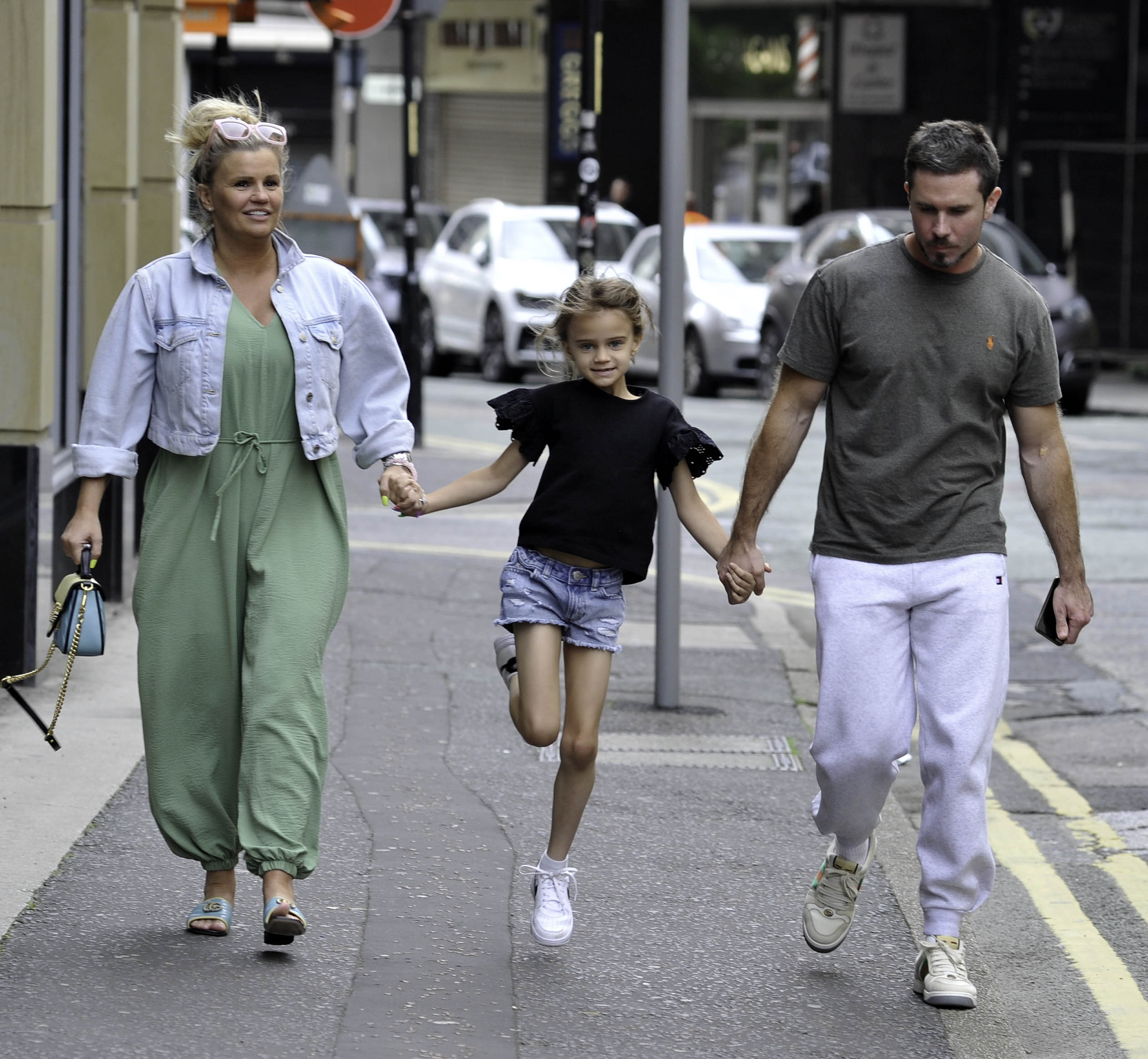 Kerry Katona holding hands with DJ and Ryan