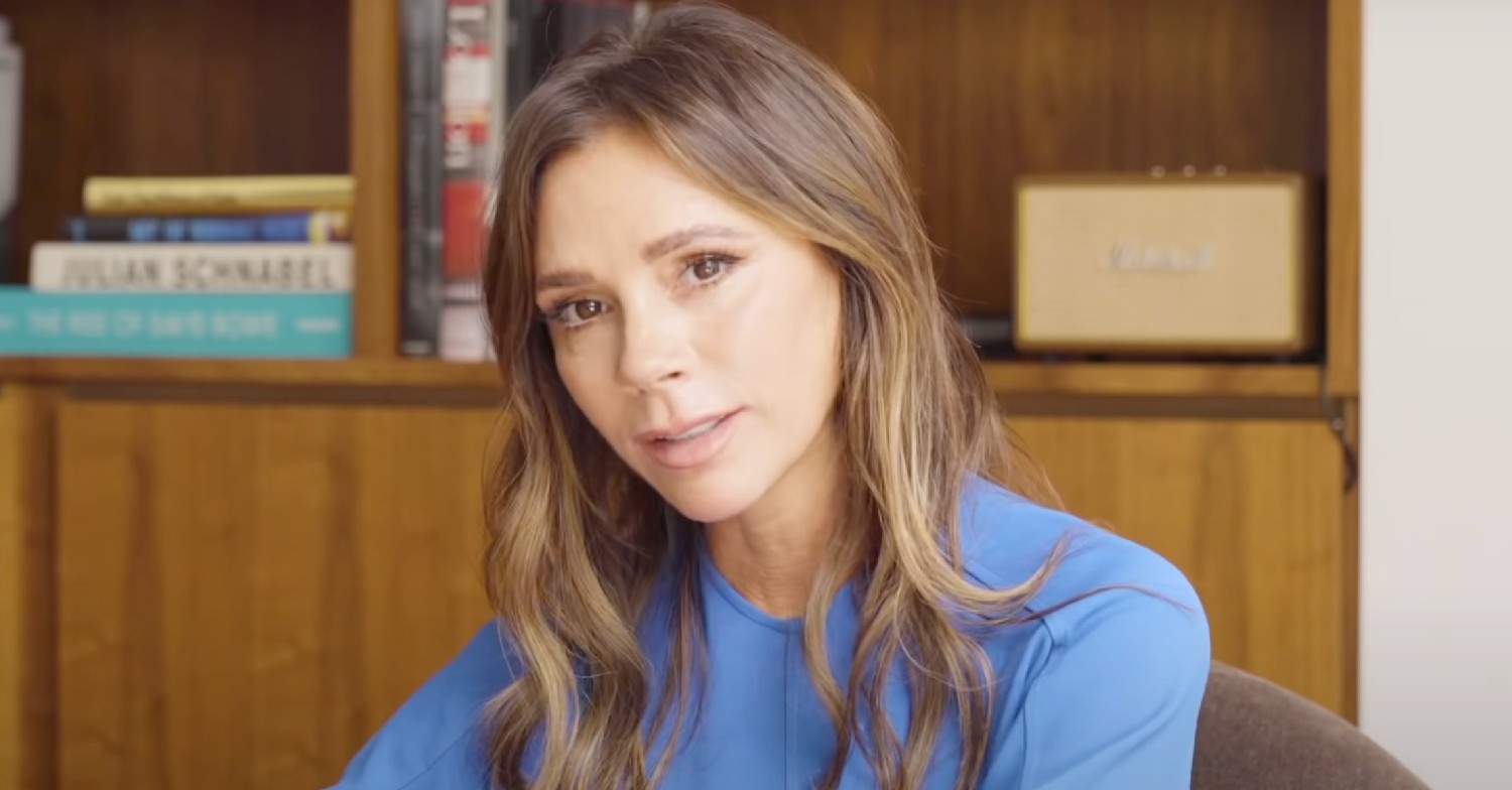 Victoria Beckham looks at camera in blue outfit