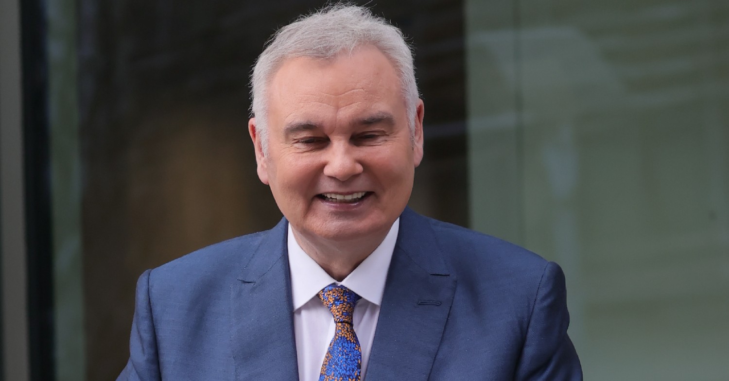 Eamonn Holmes smiles in blue suit outside GB News studios