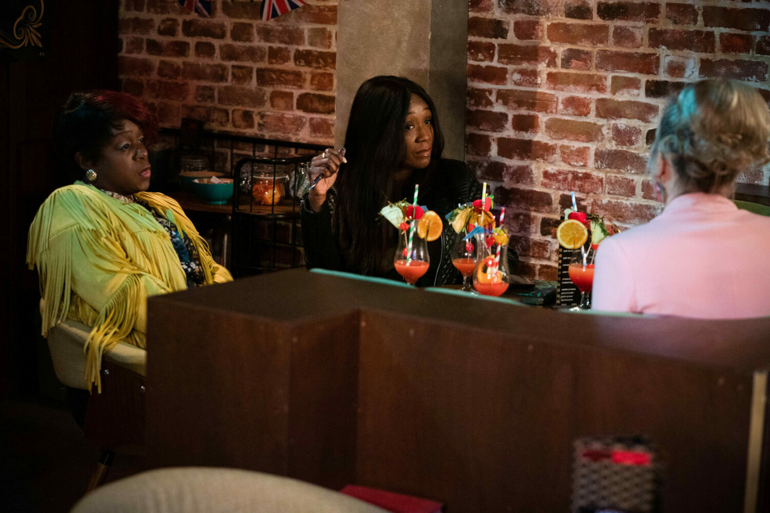 EastEnders Kim and Denise and Linda are engrossed in business talk