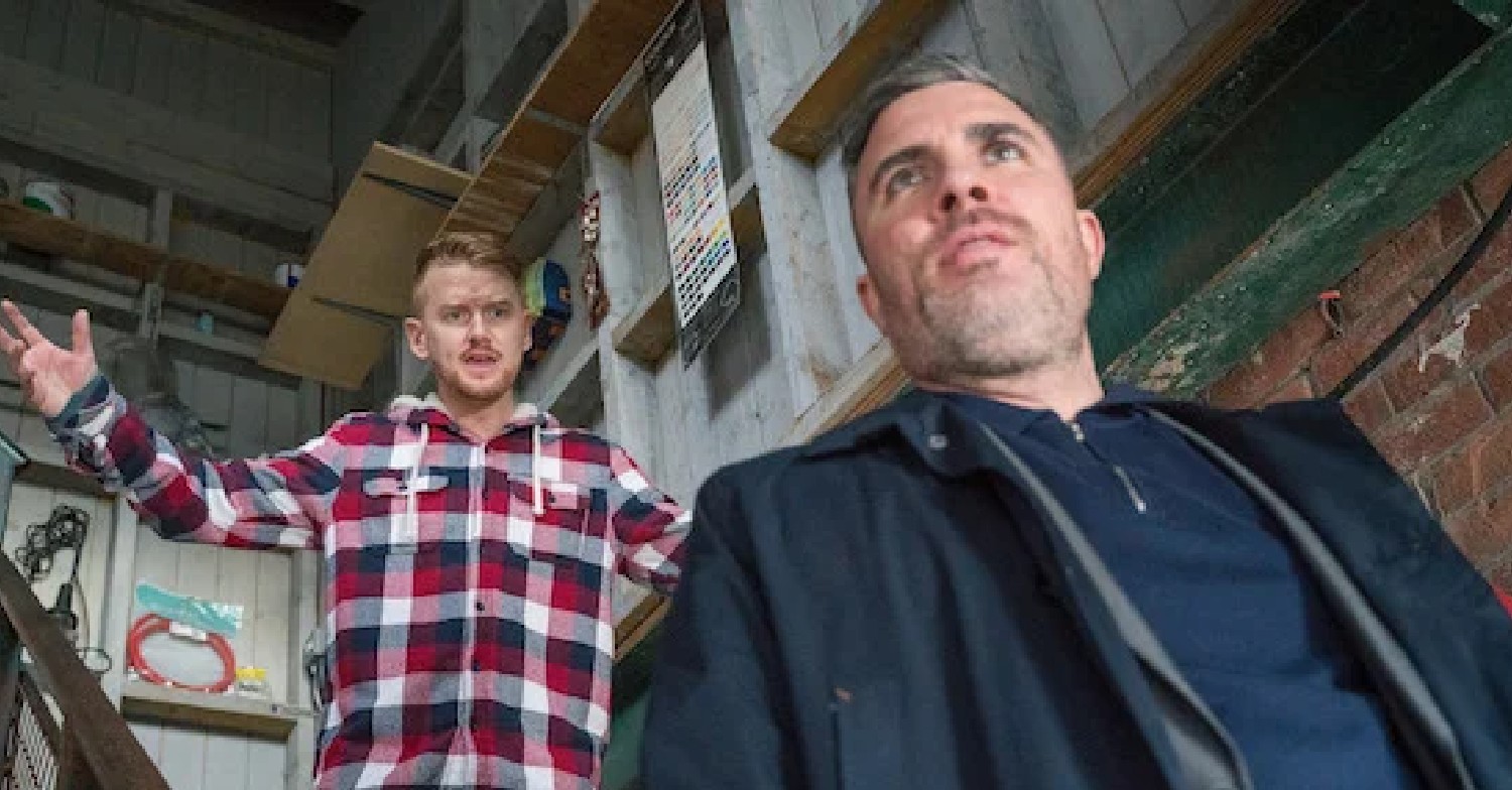 Coronation Street Gary throws his arms in the air angrily as Rick looks smug