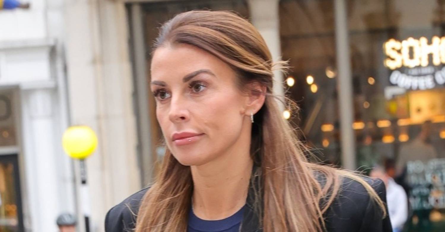 Coleen Rooney looks impassive outside of court