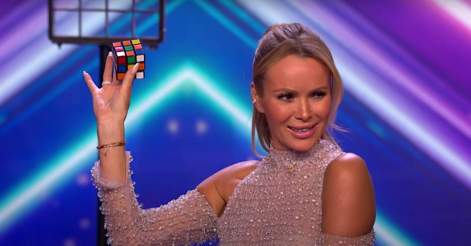 BGT judge Amanda Holden assists with a magic trick