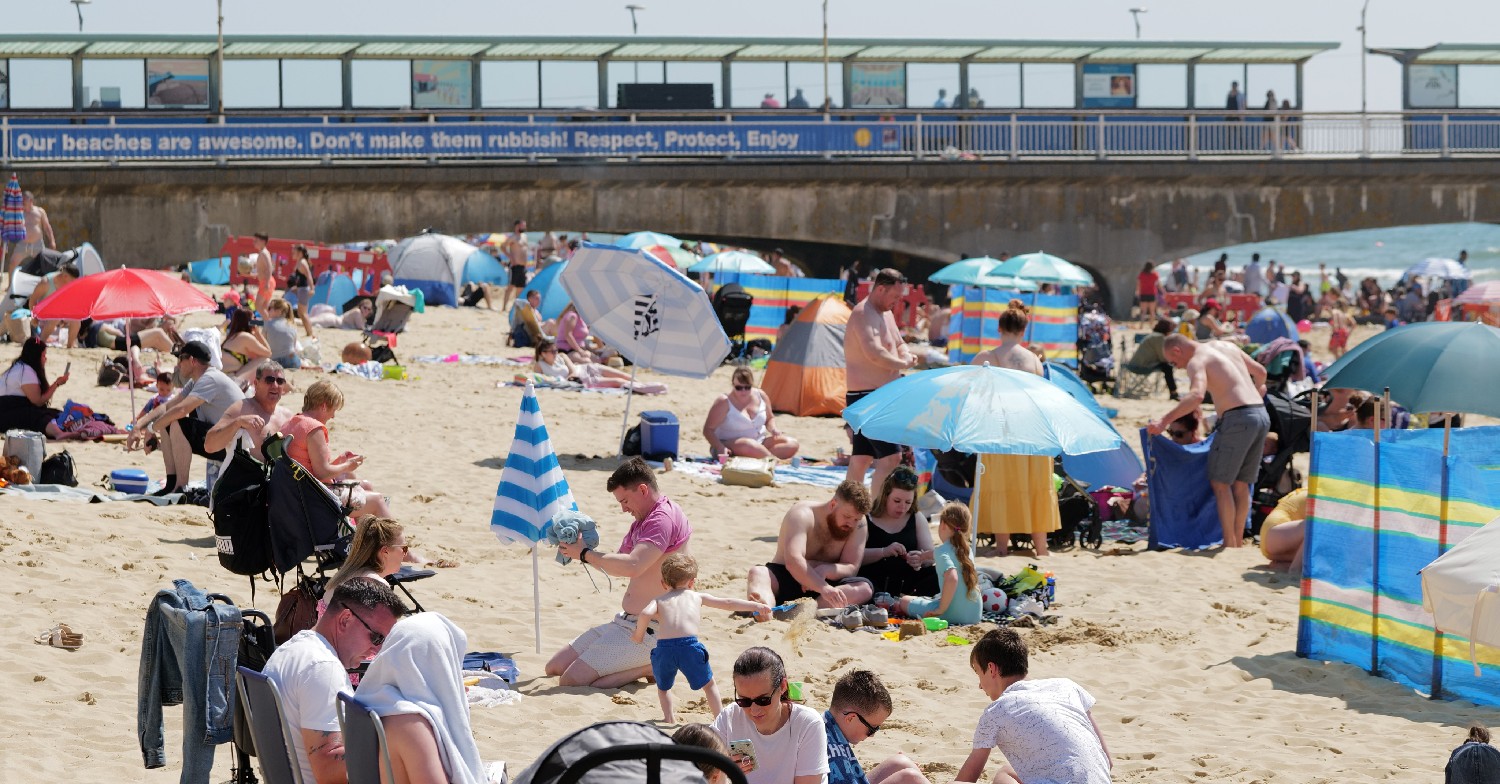 people sunbathing on a uk beach