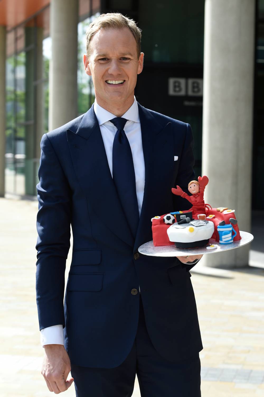 Dan Walker holds a 'goodbye' cake ahead of his move to Channel 5