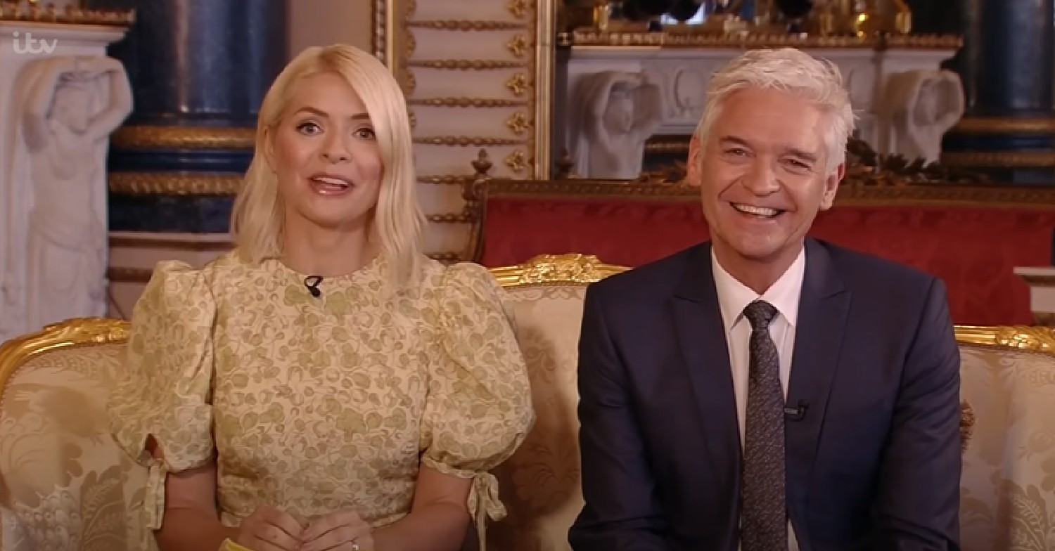 Holly Willoughby in yellow dress alongside smiling Phillip Schofield on This Morning today