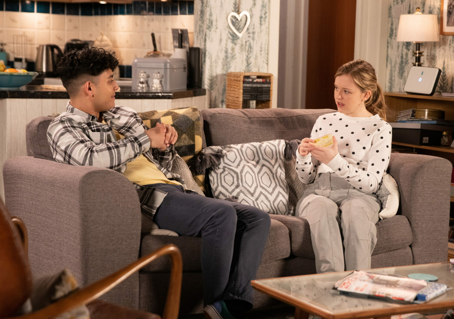 Corrie Aadi gives Summer revision cards as they talk on the sofa