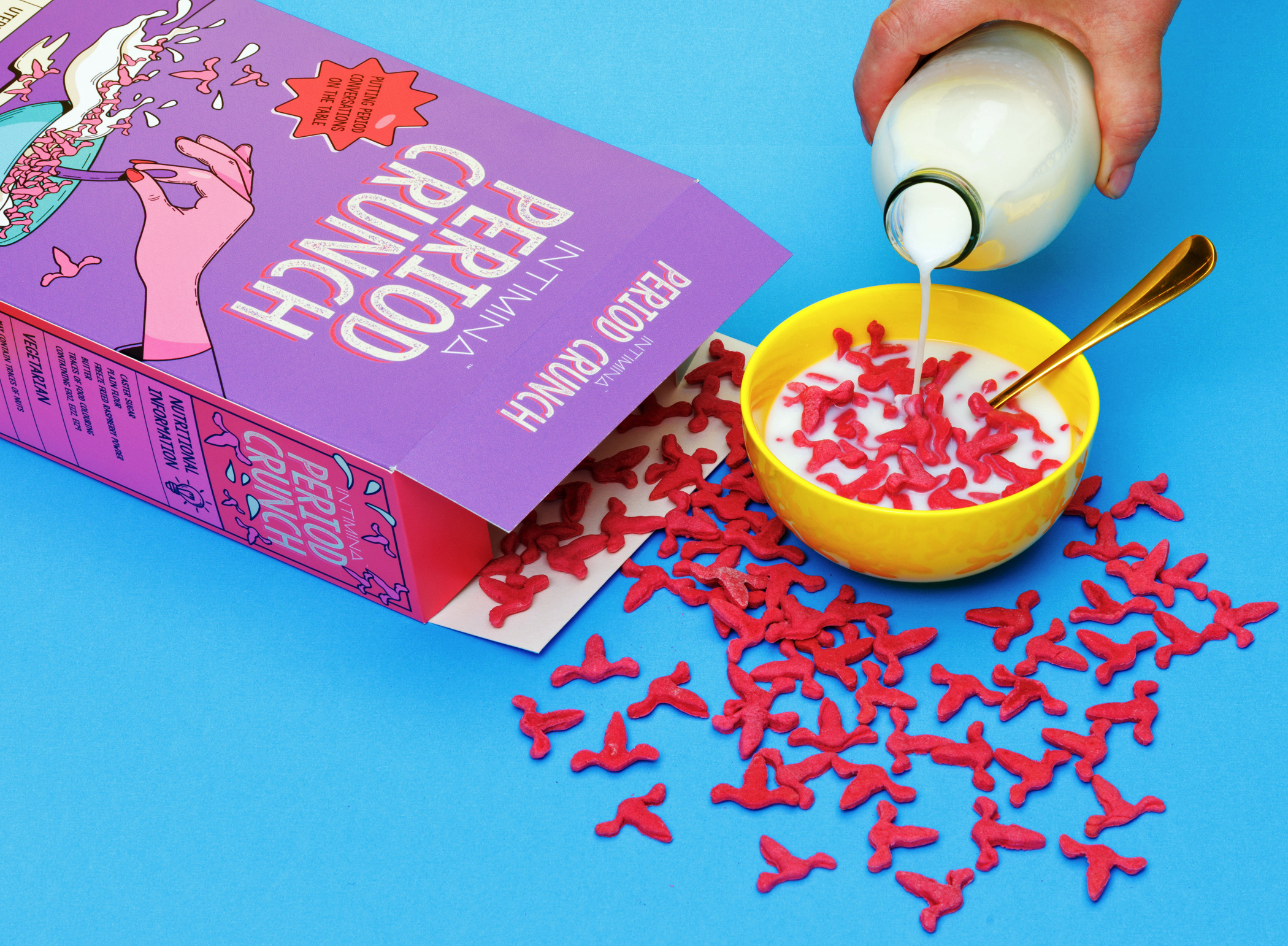 Menstrual-themed breakfast cereal Period Crunch in a bowl of milk alongside box