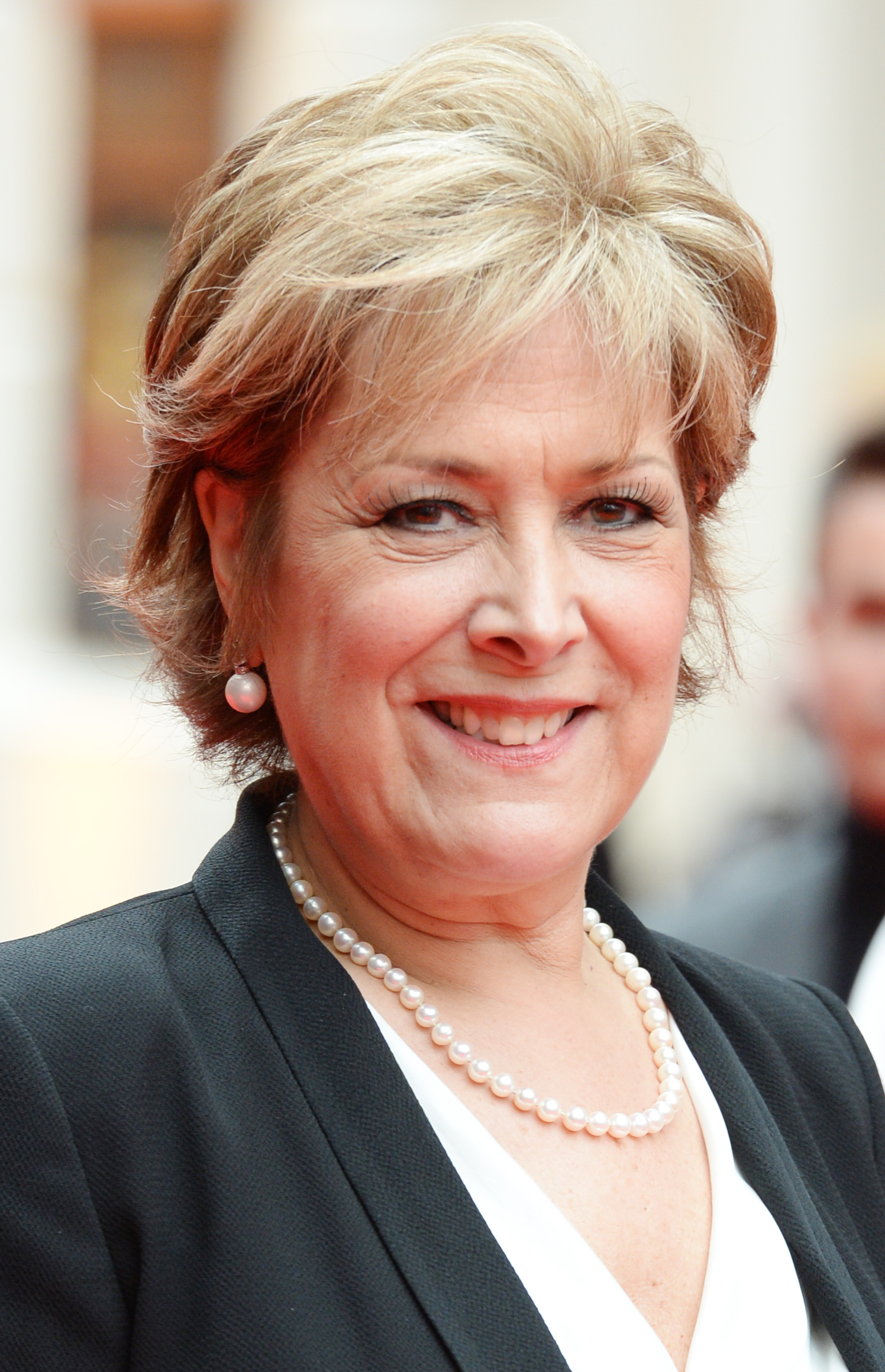 Lynda Bellingham smiling wearing a smart suit