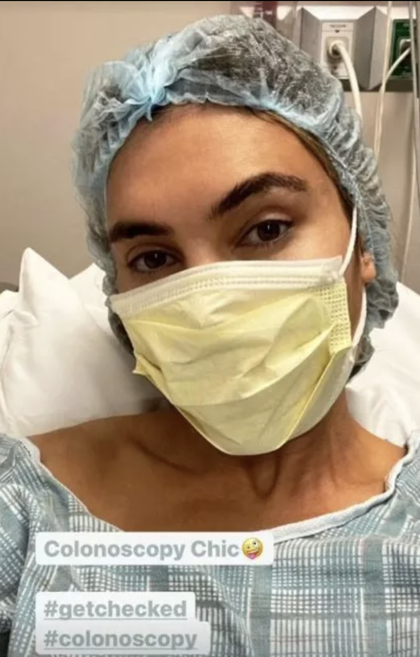 Ayda Field, Robbie Williams' wife, wearing a face mask, hospital gown and hair net in a hospital bed