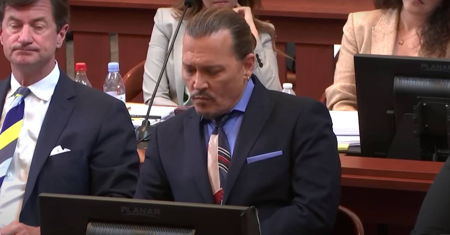 Johnny Depp looks down