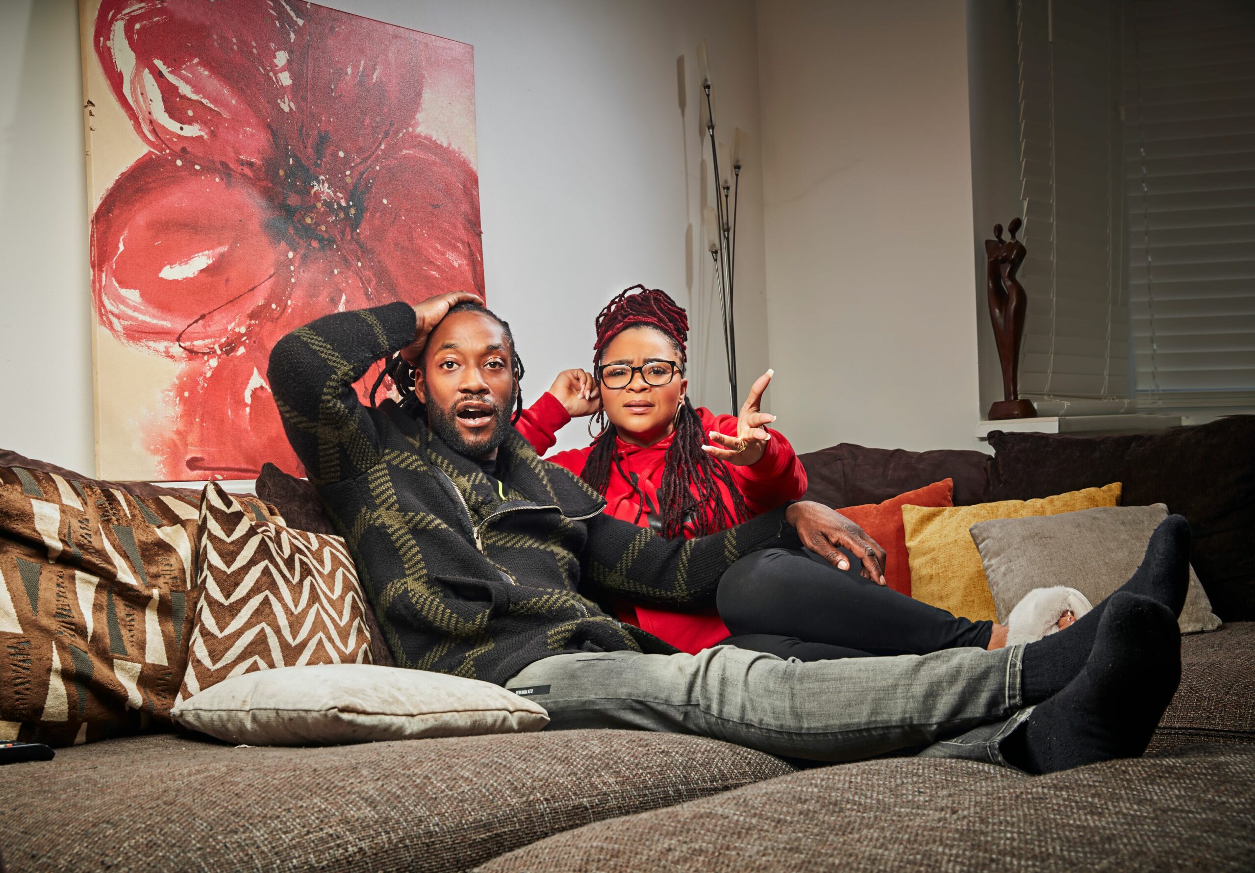Gogglebox Marcus and Mica look in shock as they watch telly from their sofa