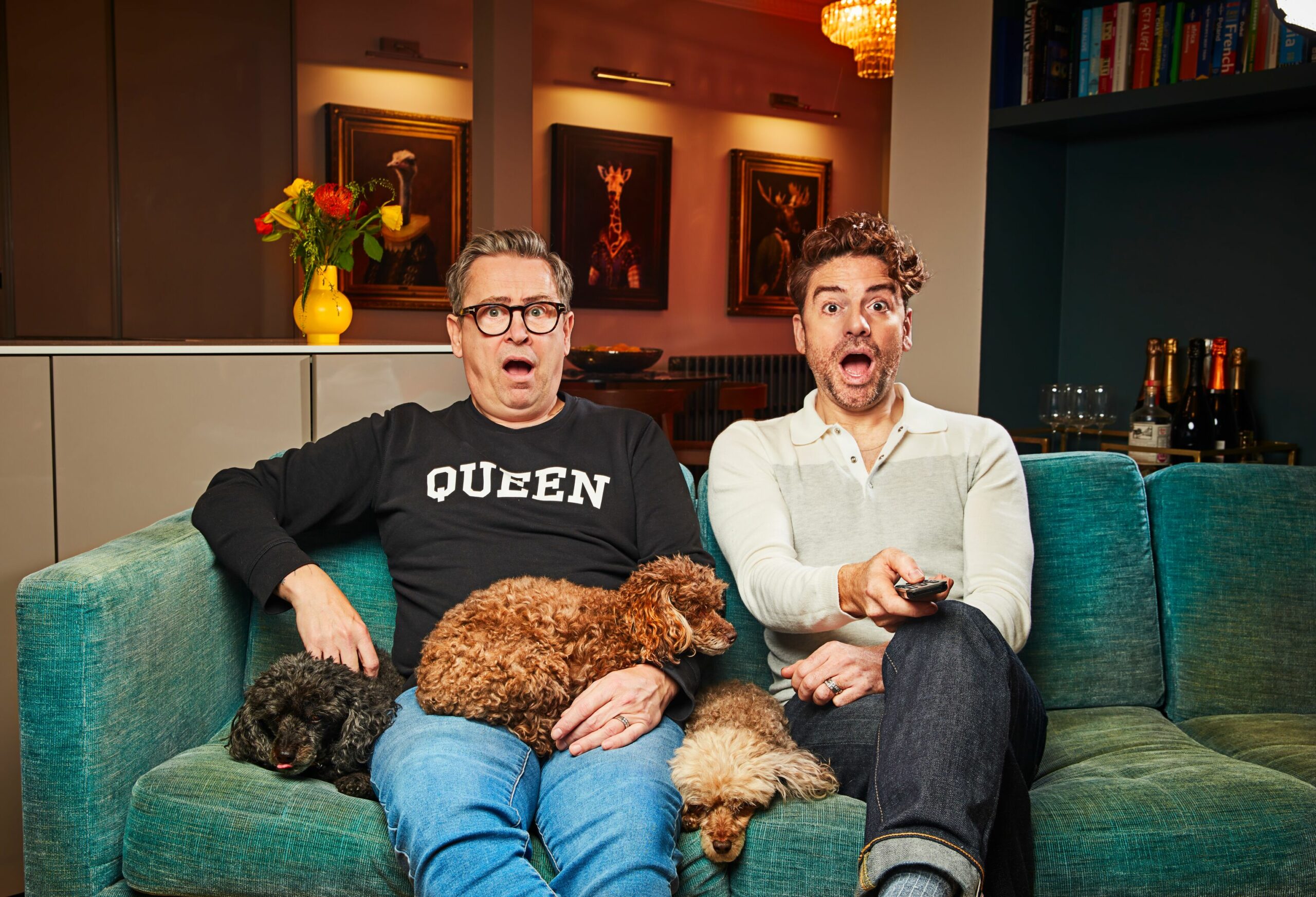 Stephen and Daniel look surprised with their dog on Gogglebox