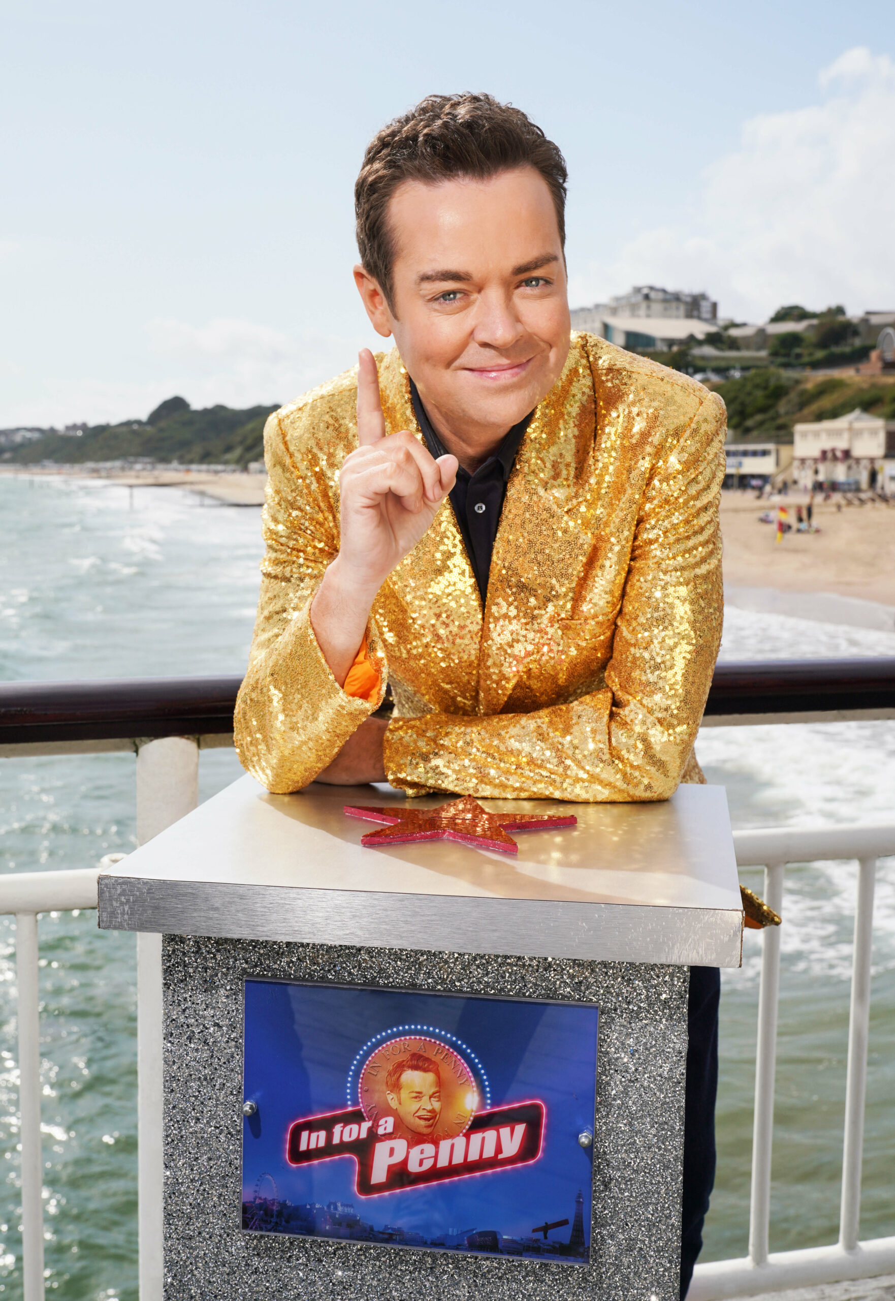 Stephen Mulhern poses with his finger pointing up for In For A Penny promo shot