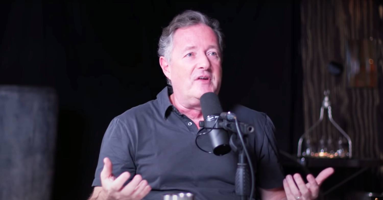 Piers Morgan raises his hands as he speaks