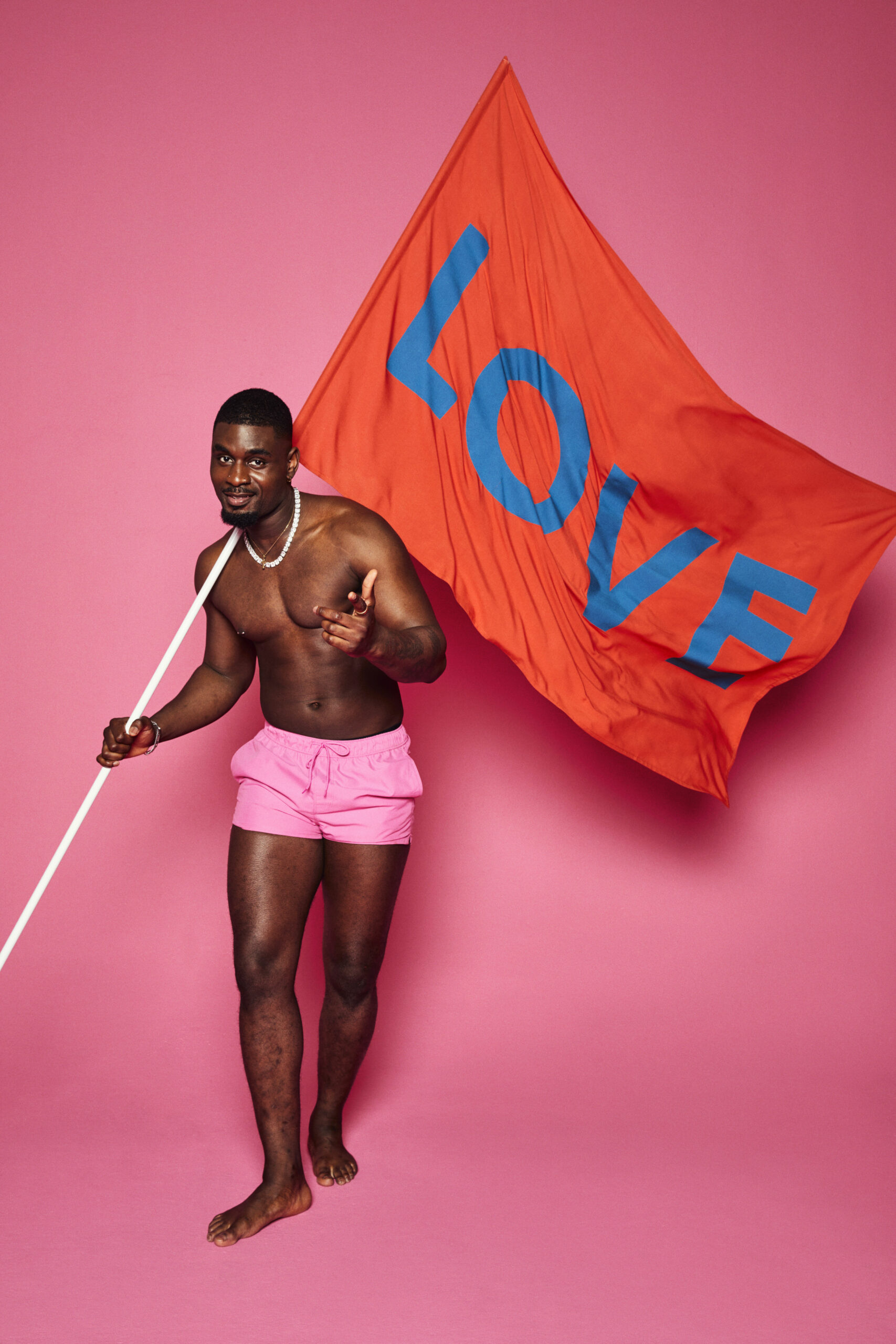 Love Island cast member holding a flag