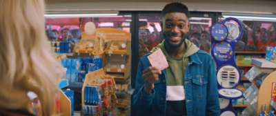 A person looking happy with their lottery ticket