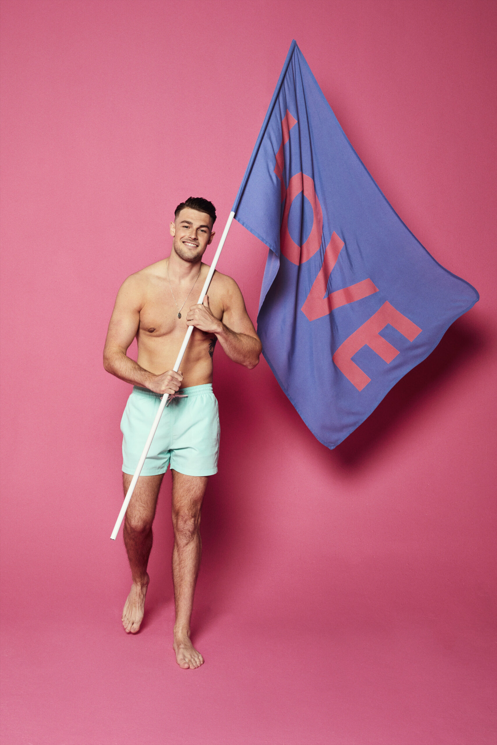 Love Island 2022 cast member in swimwear holding a flag