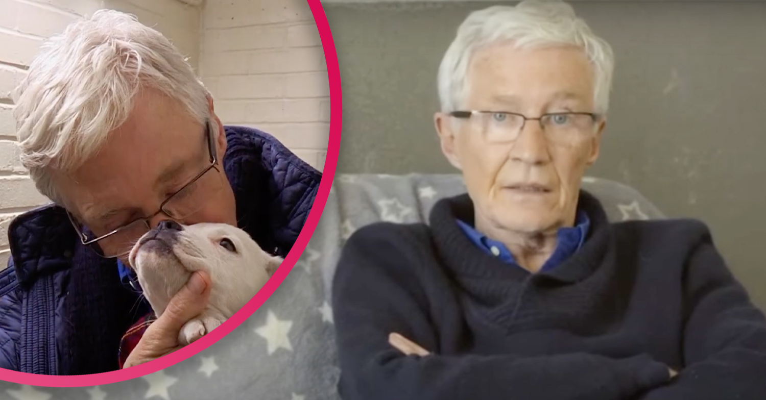 Paul O'Grady cuddling a dog