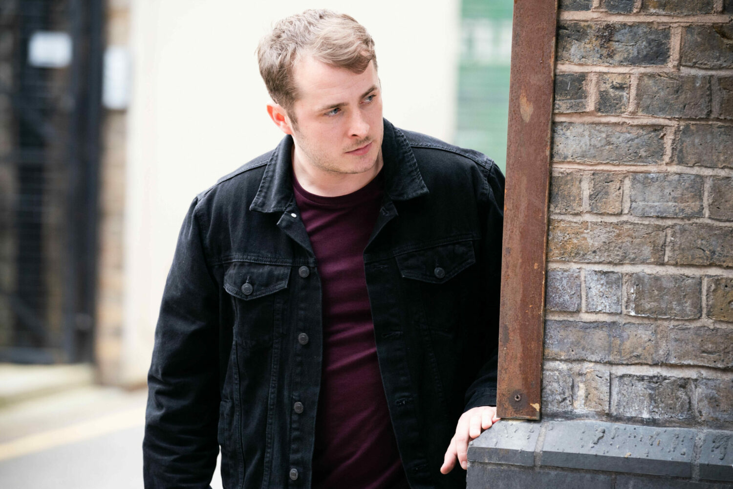 EastEnders Ben looks anxiously around a wall