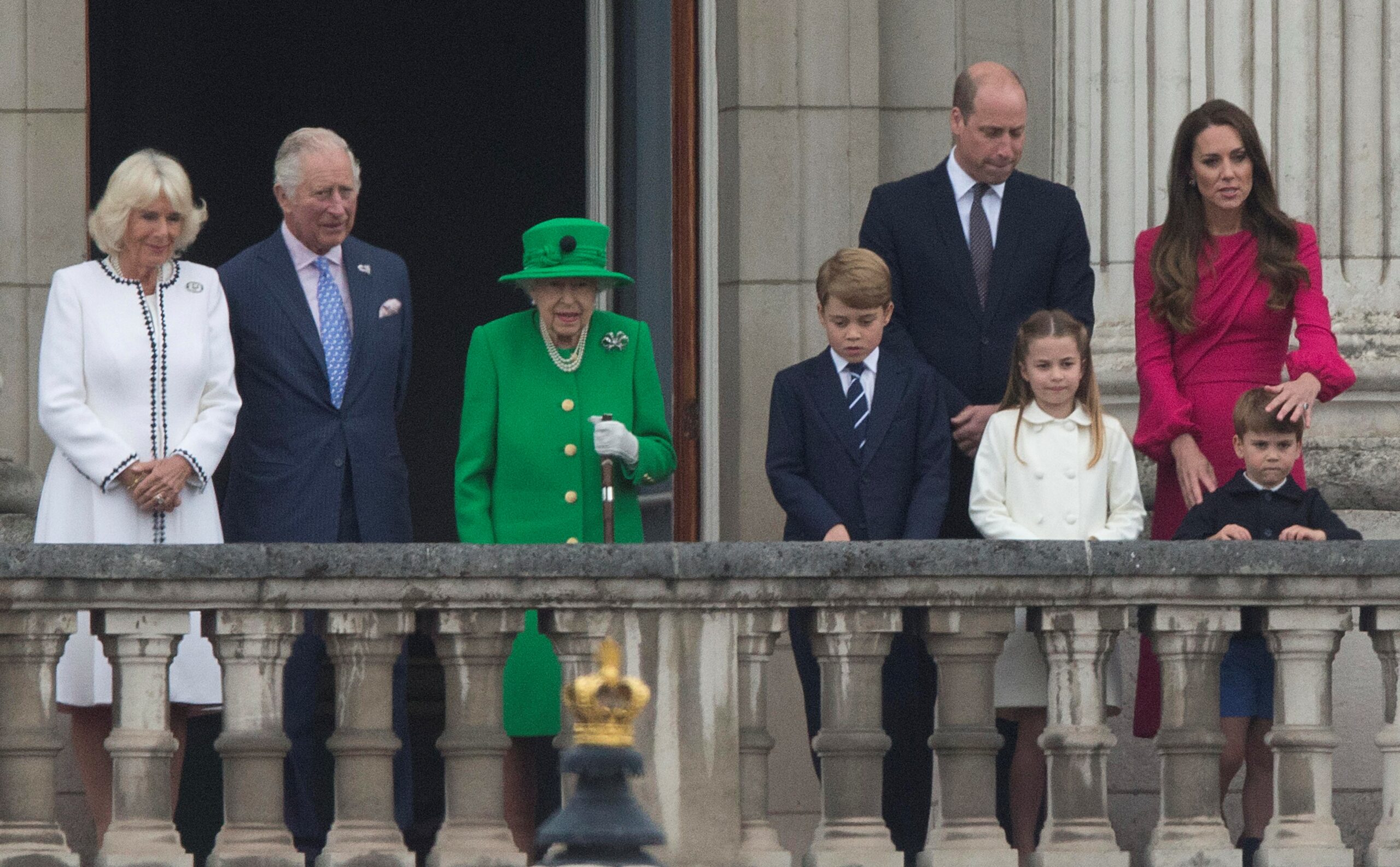 The Queen in all green as she stands on balcony with Royal Family