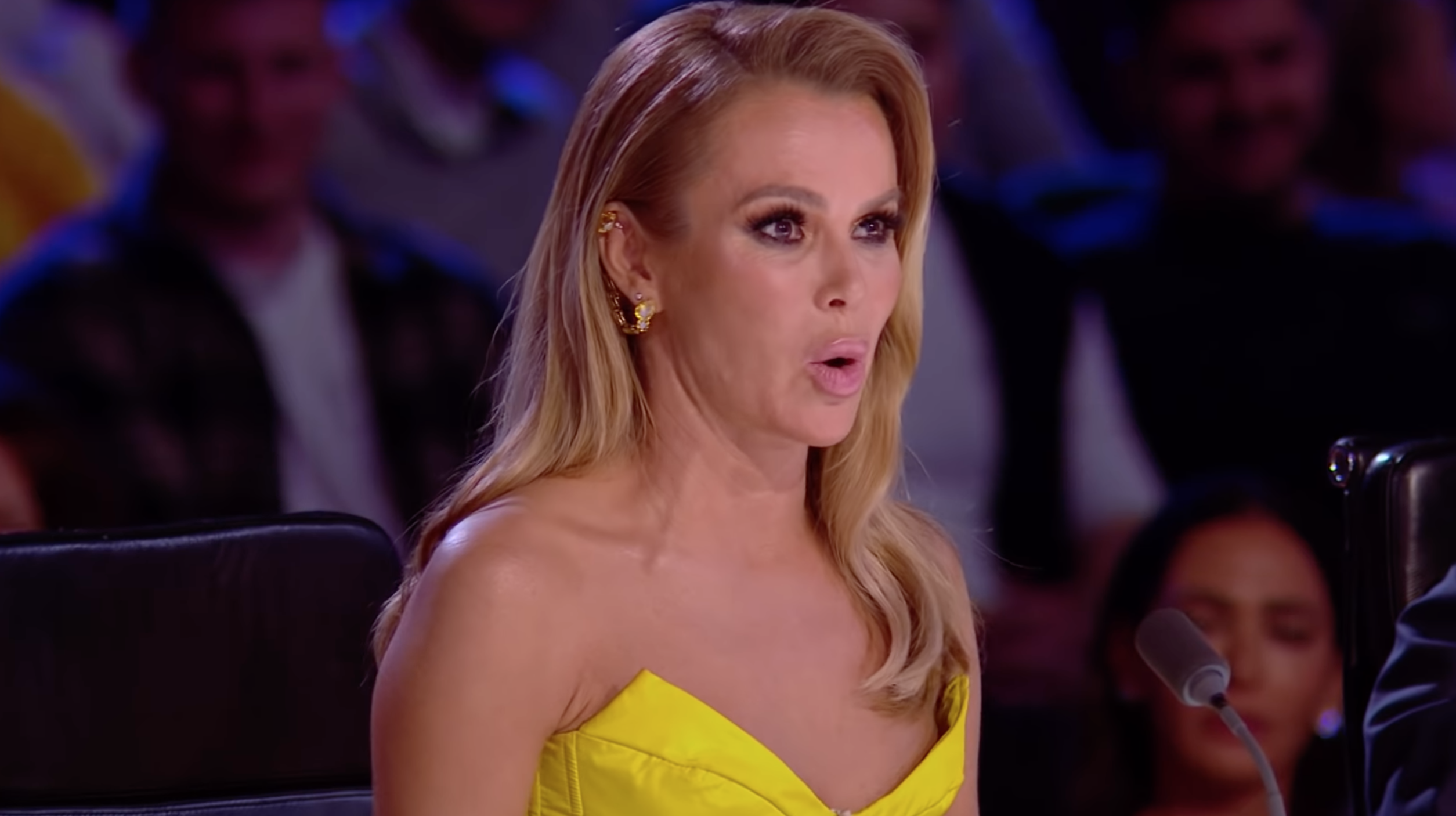 Amanda Holden speaking on the BGT 2022 final in a yellow dress