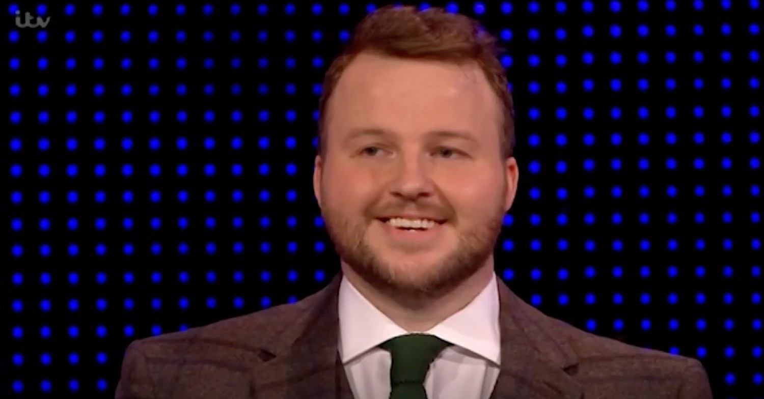 Geoff smiling in suit on The Chase 