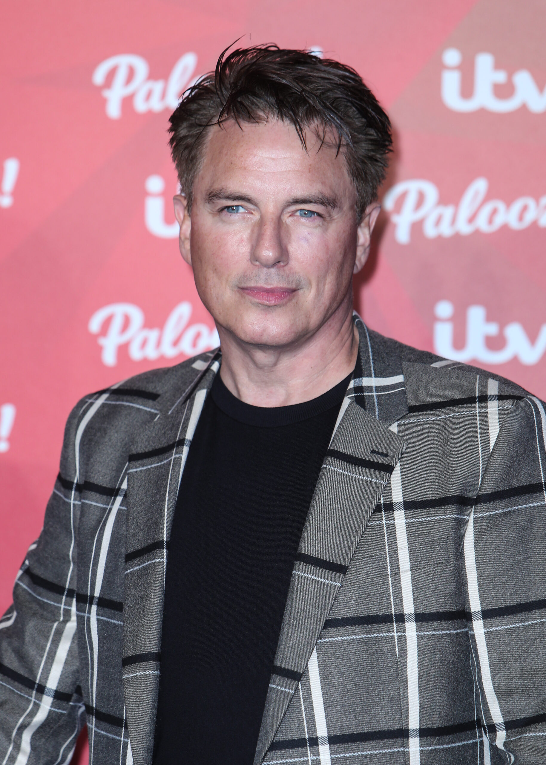 John Barrowman posing on red carpet event 