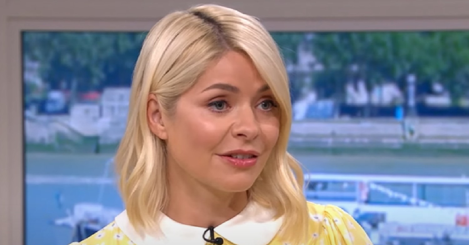 Holly Willoughby looks to the side in yellow dress on This Morning today