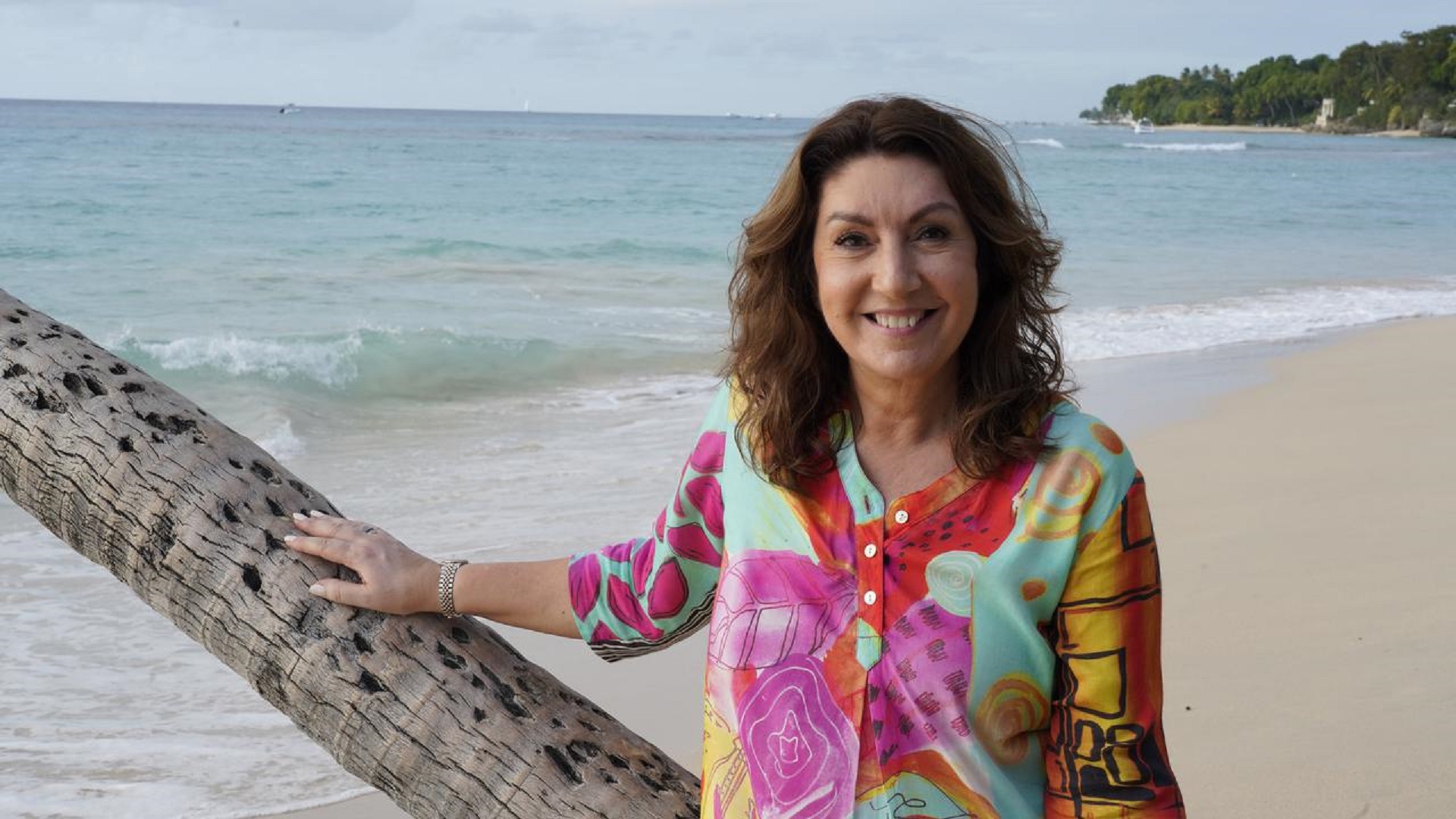 Jane McDonald in a colourful kaftan on the beach