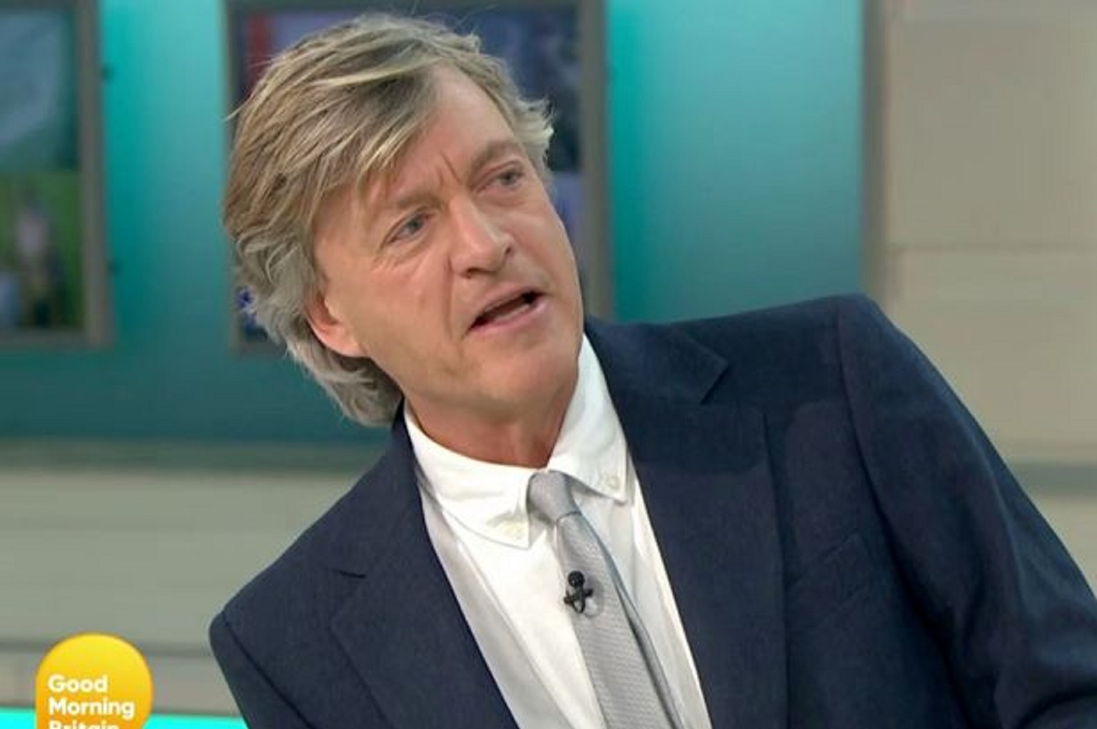 GMB presenter Richard Madeley looking to the side and serious during debate