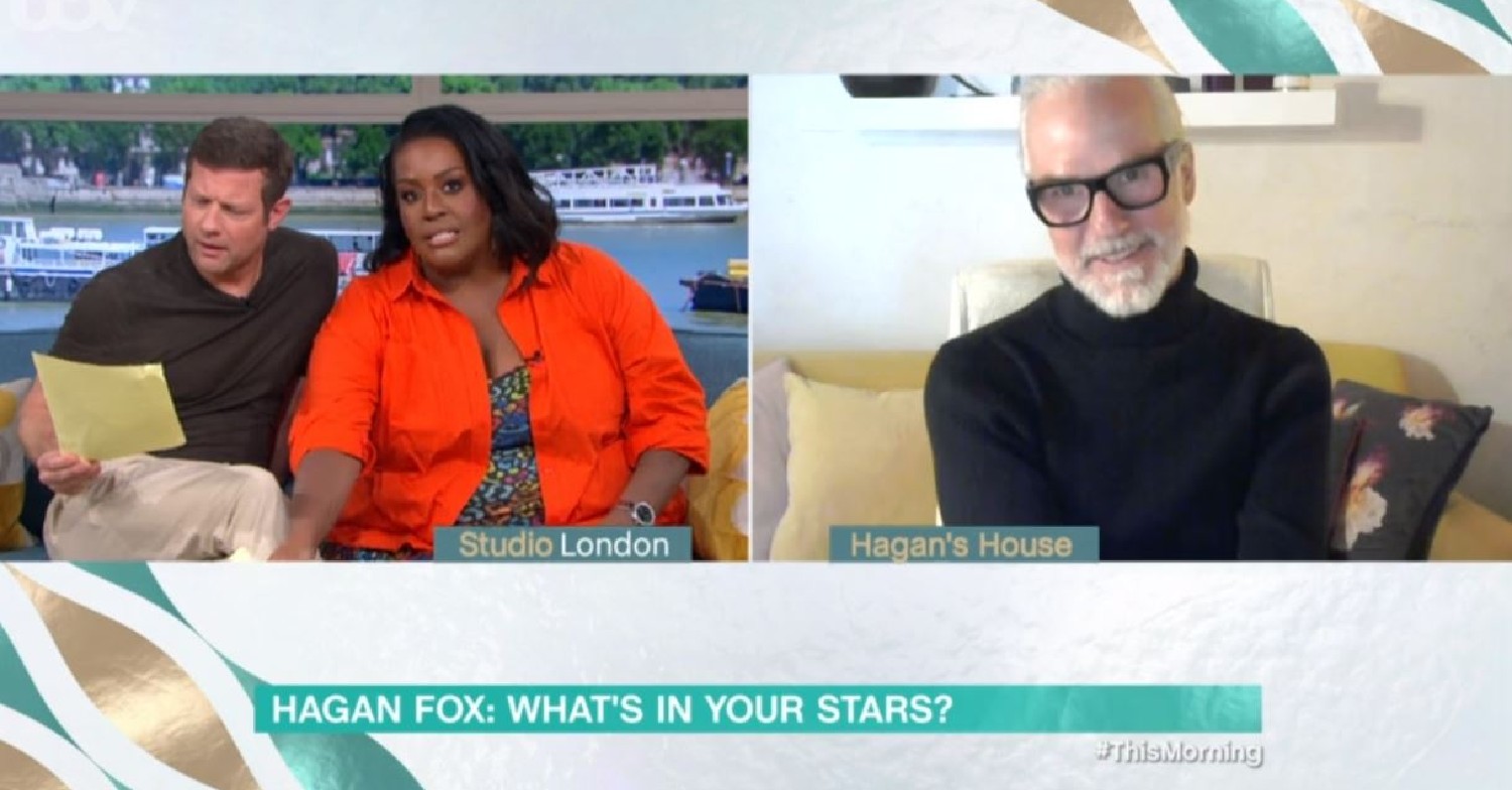 Dermot O'Leary looking confused at a piece of paper. Alison Hammond in an orange top, listening as Hagan Fox speaks via live link