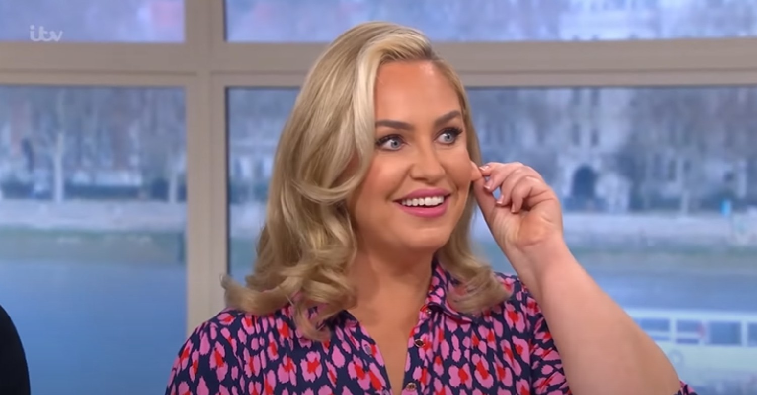 Josie Gibson touching her ear and smiling on This Morning